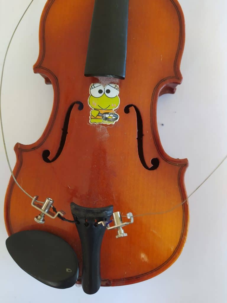 violin with all the strings removed and broken